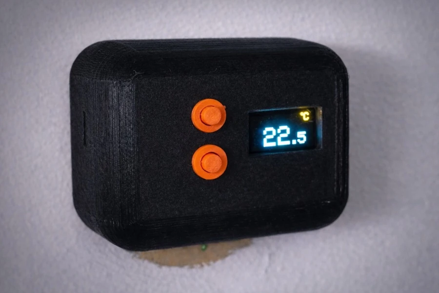 Final 3D printed smart thermostat mounted on the wall